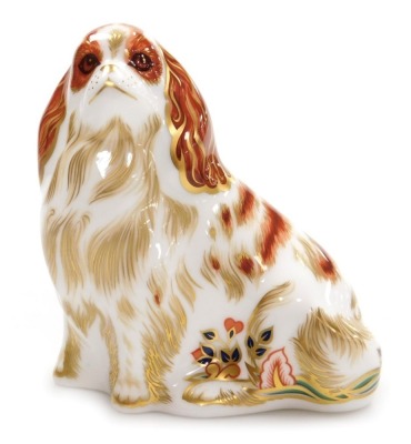 A Royal Crown Derby porcelain Cavalier King James Spaniel paperweight, red printed marks and gold stopper, 11cm high, boxed.