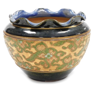 A late 19thC Royal Doulton Slater's patent stoneware jardiniere, of cylindrical tapering form, with a waved rim, the central band decorated with tube lined flowers, against a textured gold coloured base, the body in a mottled green and blue glaze, number