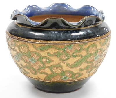 A late 19thC Royal Doulton Slater's patent stoneware jardiniere, of cylindrical tapering form, with a waved rim, the central band decorated with tube lined flowers, against a textured gold coloured base, the body in a mottled green and blue glaze, number - 2