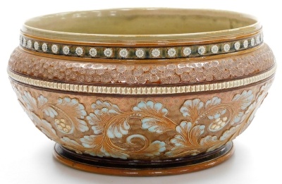 A late 19thC Royal Doulton stoneware bowl by Mark V Marshall, decorated with bands of raised flowers, incised roundels, flowers, leaves, etc., in greens, oranges and blues, model number 4133, impressed marks and monogram MVM, 14cm high, 28cm diameter. - 2