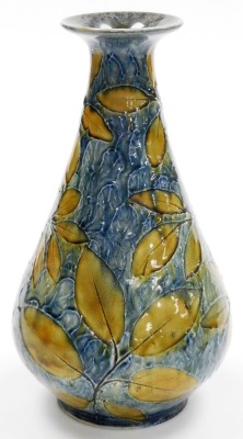 A Royal Doulton stoneware Natural Foliage vase, of cylindrical tapering form, with a flared neck and rim, on a circular base, impressed decorated with leaves against a mottled green and blue ground, model number X6352, impressed marks, 31cm high. - 2