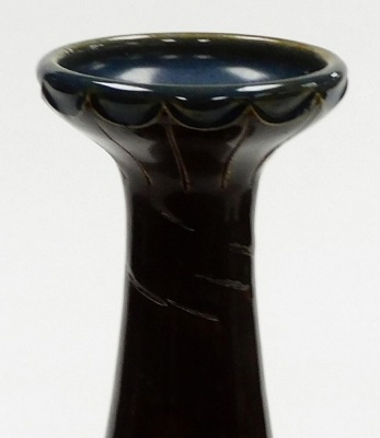 A late 19thC Royal Doulton Lambeth stoneware vase by Rosina Brown, of cylindrical tapering form with an elongated neck, decorated with blue and green flowering branches, with raised bead decorations against a two tone brown ground, model number 706, impre - 4