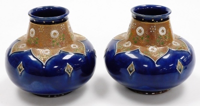 A pair of late 19thC Royal Doulton stoneware vases, each of cylindrical squat form, the raised neck decorated with flowers, the body decorated with diamond motifs against a mottled blue ground, model number 8353, impressed marks, each 15.5cm high. - 2