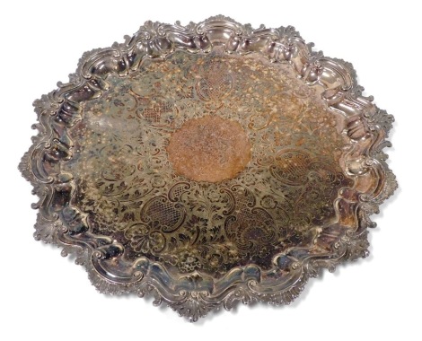 A 19thC silver plated tray, of circular form with an embossed scroll border and etched centre, unmarked, 49cm diameter.