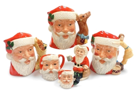 A group of Royal Doulton pottery Santa Claus character and Toby jugs, comprising three character jugs, D6690, D6675, and D6668, together with two miniature examples, D607 and D699, and a Father Christmas Toby jug, D6940.