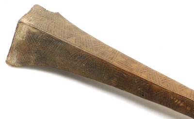 A 19thC Tongan Apa Apai war club, of dense hardwood, the tapering diamond shaped head carved with panels of geometric bands of chevrons, continuing with a plain cylindrical shaft, terminating in a triangular grip with suspension hole, 85cm wide. (AF) - 3