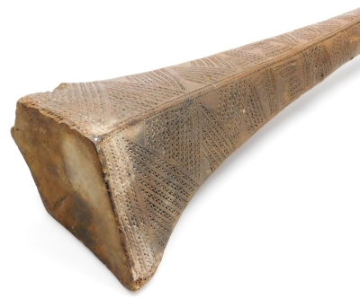 A 19thC Tongan Apa Apai war club, of dense hardwood, the tapering diamond shaped head carved with panels of geometric bands of chevrons, continuing with a plain cylindrical shaft, terminating in a triangular grip with suspension hole, 85cm wide. (AF) - 4