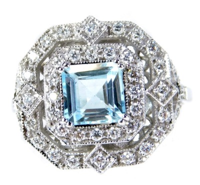 An Art Deco style aquamarine and diamond double halo ring, with a central asscher cut aquamarine, approx 1.20ct, surrounded by two halos of round cut diamonds, totalling approx 0.58ct, on an 18ct white gold band, size N, 4.3g all in.