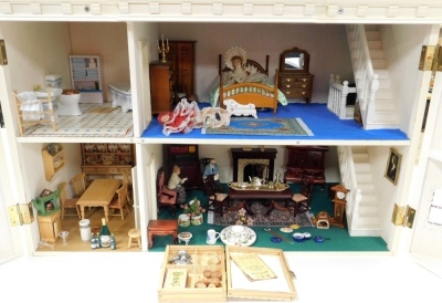 A doll's house, with a central pediment and portico, flanked by double bays, opening to reveal four rooms, with a further room in the roof, with furniture, 71cm high, 78.5cm wide, 44cm deep. - 3