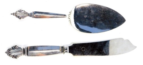 Two pieces of Georg Jenson acanthus pattern silver, being an cake slice with import marks for London 1958, 2oz, and a silver handled fish slice stamped 'Sterling Denmark'. (2)