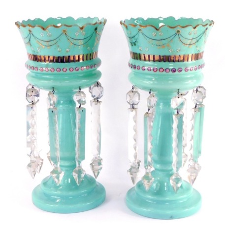 A pair of late 19thC Continental turquoise glass lustres, with gilt and enamelled floral decoration, with clear glass prismatic drops, 36cm high.