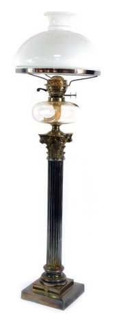 A Victorian silver plated Corinthian column oil lamp, with a clear glass reservoir and white glass shade, 98cm high.