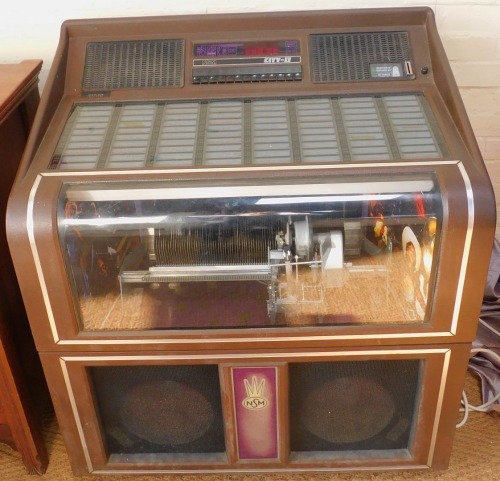 A 1980s NSM City-II juke box, with capacity for eighty 45rpm records and one hundred and sixty tune selections, coin operated, with records and keys, 102cm high, 92cm wide.