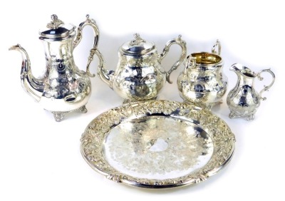 A Victorian electroplate four piece tea set, with heavy scroll detail and acorn finials, comprising teapot, coffee pot, milk jug, sugar bowl, together with a tea tray, engraved and embossed with flowers and scrolling leaves. (5)