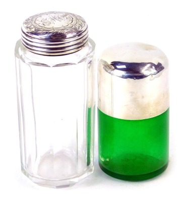 Two silver dressing table jars, comprising a green glass smelling salts jar, with silver lid, and a Victorian cut glass jar, with silver lid, monogram engraved, Birmingham 1899. (2)