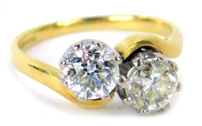 An 18ct gold diamond two stone twist ring, set with two bold cut diamonds, each stone approx 0.87ct, in a platinum claw setting, on a yellow metal band, ring size K½, 4.2g all in, assessed colour H-J, clarity I1/2.