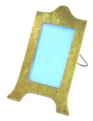 A World War I Trench Art easel strut photograph frame, commemorating Poelcapelle, dated 1919, with additional floral stipple engraving, 20cm high, 14cm wide.