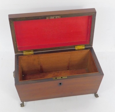 A late Regency mahogany sarcophagus form tea caddy, with brass lion's head and ring handles, the hinged lid opening to reveal a vacant interior, raised on ball and claw feet, 21cm wide. - 2