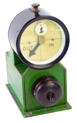 An early 20thC painted metal and Bakelite signal indicator, with an in out barrel dial and a Bakelite switch below, 22cm high.