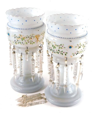 A pair of late 19thC milk glass lustres, decorated in enamel with a band of flowers, with clear prismatic glass drops, 36cm high.