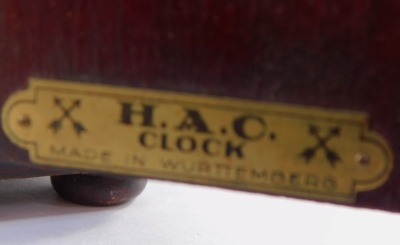 An early 20thC Hamburg American Clock Company mahogany cased mantel clock, circular silver dial bearing Arabic numerals, eight day movement with coil strike, the case of domed form, raised on bun feet, with pendulum and key, 28cm wide. - 3