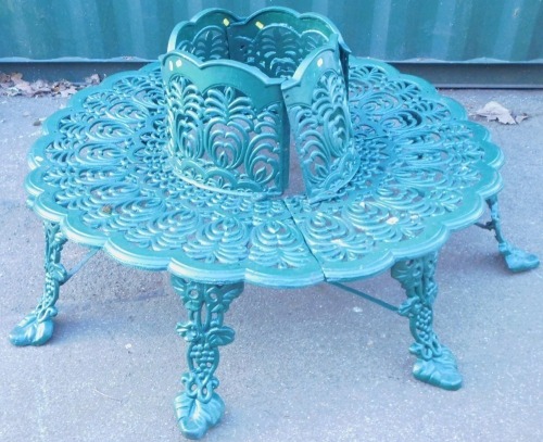 A Victorian style cast iron garden bench in the Coalbrookdale manner, green, to go around a tree trunk, 93cm high, tree girth 50cm diameter, bench 133cm diameter.