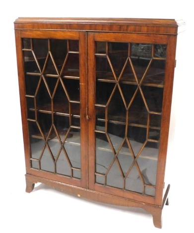 An Edwardian mahogany display cabinet, with two astragal glazed doors, and a fitted three shelf interior, on bracket feet, 143cm high, 14cm wide, 33cm deep. (AF)