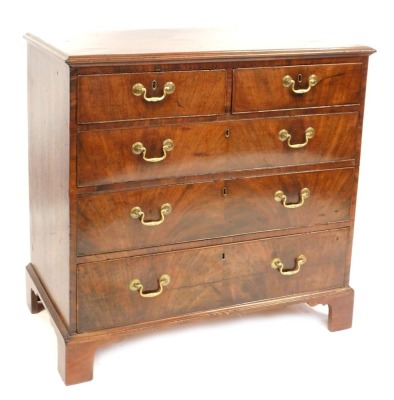 A George III oak chest of two short and three long drawers, with brass swing handles, on bracket feet, 91cm high, 93cm wide, 51cm deep.