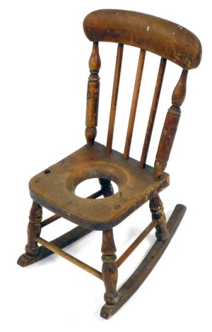 A Victorian child's oak and beech ladder back commode rocking chair, 65cm high. (AF)