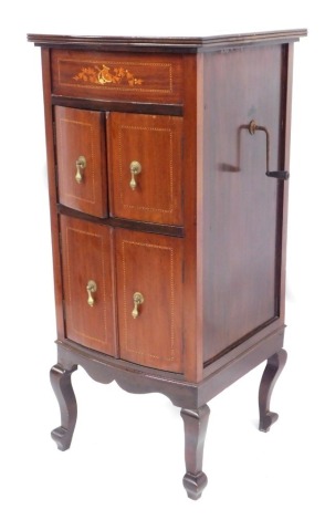 An Edwardian mahogany gramophone cabinet, with inset record player, above arrangement of two cupboards, on out splayed feet, marquetry inlay, 110cm high, 49cm wide, 46cm deep.