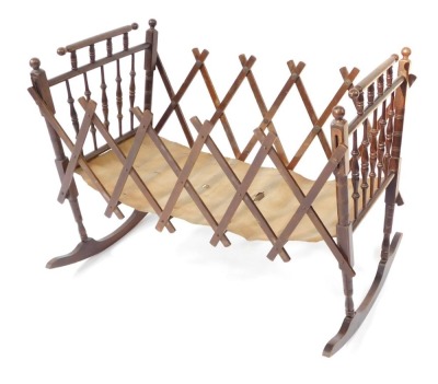 A late 19thC beech folding cradle, with canvas lined base, 70cm high.