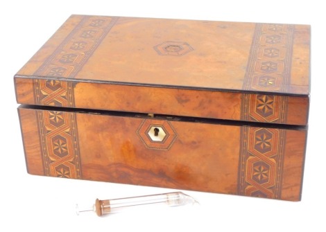 A Victorian walnut and inlaid writing box, the hinged lid opening to reveal a fitted interior, with mother of pearl key escutcheon, 14cm high, 35cm wide, 23cm deep. (AF)