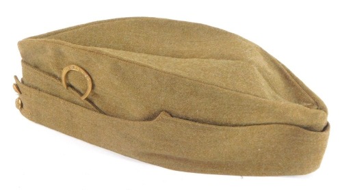 A WWII Army side cap, with Rutland Horseshoe badge, dated 1941, 30cm wide.