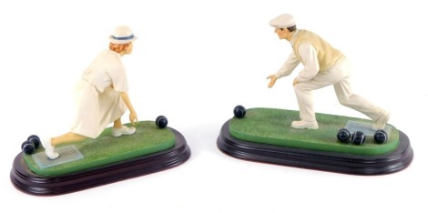 A pair of Leonardo Collection figures of bowlers, raised on oval wooden bases, 25cm wide.