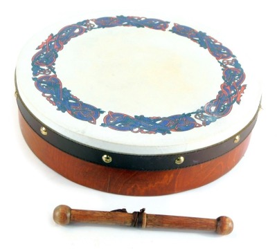 An Irish bentwood and hide bound bodhran, decorated to the top with a Celtic design, with beater, 31cm wide.