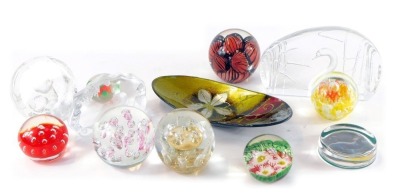 A group of glass paperweights, including a Mats Jonasson cameo glass paperweight of a kitten with a ball of string, two further cameo glass paperweights of a seal and a swan, together with an oval enamelled dish. (a quantity)