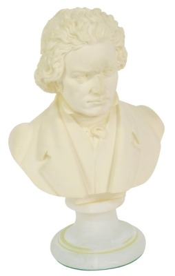 A plaster bust of Beethoven, raised on an alabaster socle, 23cm high.