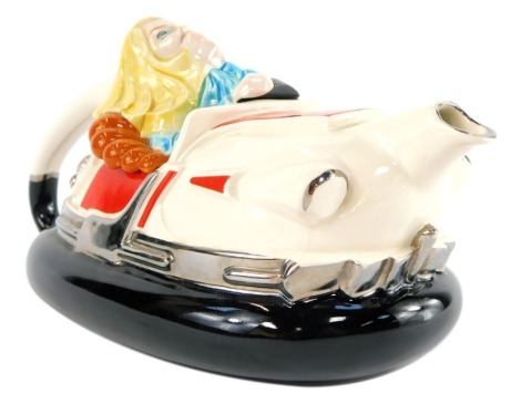 A Silver Crane Company novelty teapot modelled as a dodgem car, with lady driver, printed mark, 29cm wide.