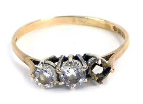 A 9ct gold diamond set three stone ring, with three stones each in six claw setting, one stone missing, in a raised basket, size S, 1.8g all in.