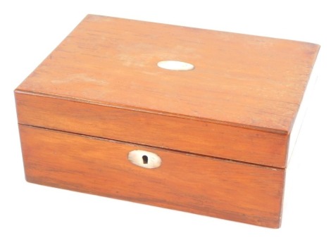 A Victorian mahogany box, with mother of pearl escutcheons, the hinged lid opening to reveal a vacant interior, 10cm high, 25cm wide, 17.5cm deep.