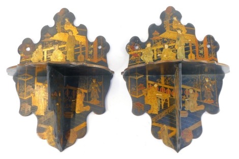 A pair of late 19thC Japanned lacquer folding wall shelves, decorated with figures in a garden setting, 27.5cm high.