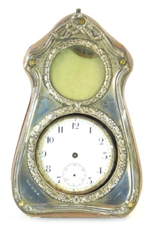 An Edward VII silver mounted pocket watch case, in a brown leather case with a silver foliate front, Birmingham 1907, enclosing a plated pocket watch with white enamel dial, 11cm high. (AF)