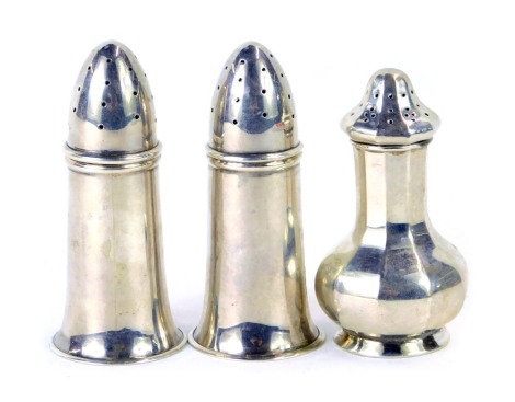 A pair of George V silver pepper pots, each of a plain design, Birmingham 1926, and an octagonal pepper pot, Birmingham 1922, 2.52oz. (3)