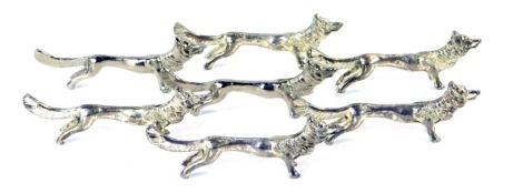 Seven silver plated fox knife rests. (7)