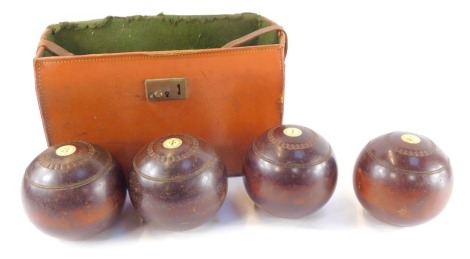 Four Thomas Taylor of Glasgow lignum vitae bowls, bone inset, with numbering, impressed marks, cased.