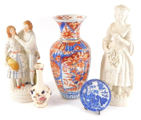 A Chinese porcelain Imari vase, decorated with panels of flowers, 29.5cm high, Masons Mandalay pattern posy vase, Parrot and Company blue and white willow pattern saucer, late 19thC Parian ware figure of a 'flower sellers', 34.5cm high, and a painted Pari