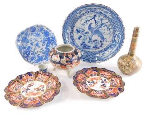 A Japanese blue and white dish, decorated with a peacock and flowers, 21cm wide, Japanese blue and white decorated blue shell shaped dish, blue and white sake cup, Chinese Imari fluted vase, two Foley Imari plates, and a Satsuma vase. (7)