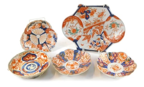 A group of Japanese and Chinese Imari dishes, decorated with reserves of flowers.