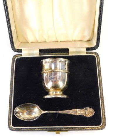 A George VI silver child's egg cup and spoon, with a moulded border inscribed Ann 12-11-39, with a shell pattern spoon, Birmingham 1938, 1.45oz, in fitted case.