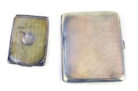 A George V silver engine turned cigarette case, Birmingham 1932, and associated silver match sleeve bearing initials E L to the circular reserve, containing matches for The Connaught Room, Birmingham 1924, 3.5oz. (2)